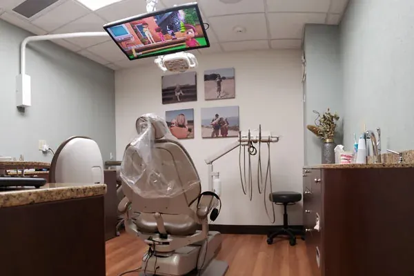A treatment room at Cooley Smiles with a chair-side television.