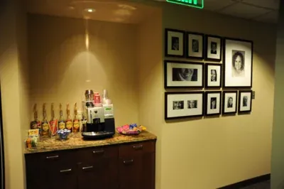 The coffee station beside a wall of framed photographs.