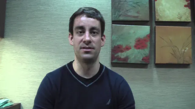 A Cooley Smiles patient speaking to camera in the practice consultation room.